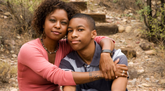 african american woman with her arm around her son