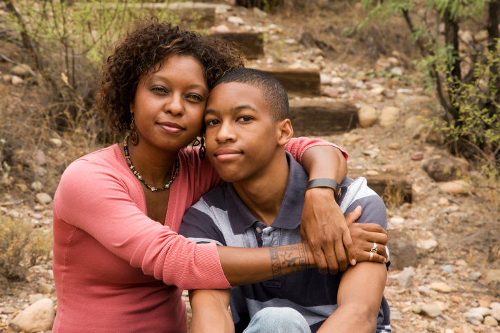 african american woman with her arm around her son