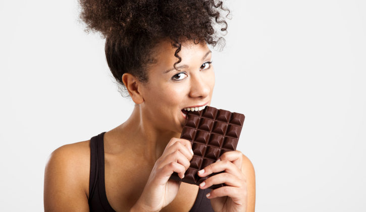 woman eating a big bar of chocolate