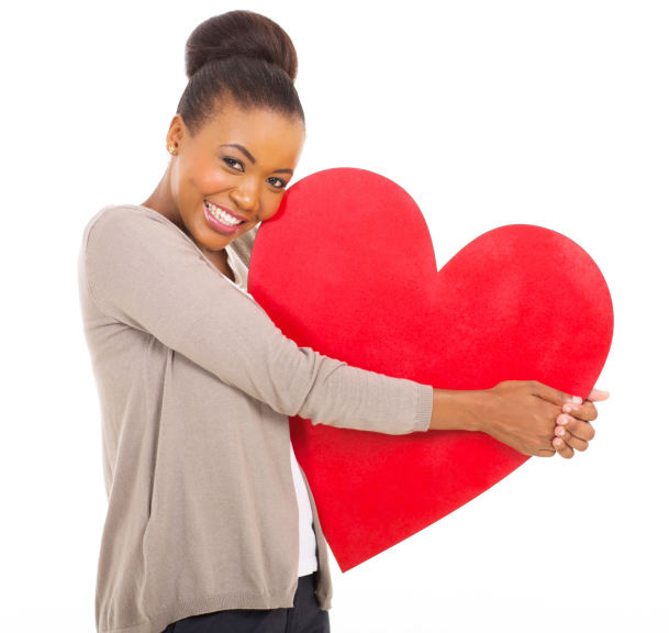 woman hugging large red heart