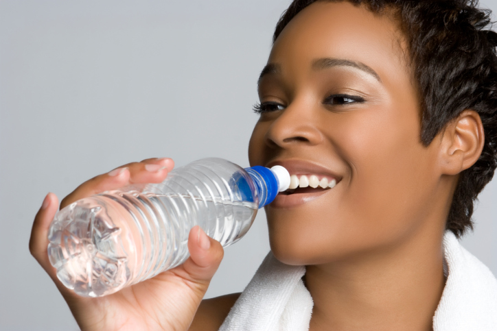 close up woman drinking bottle water