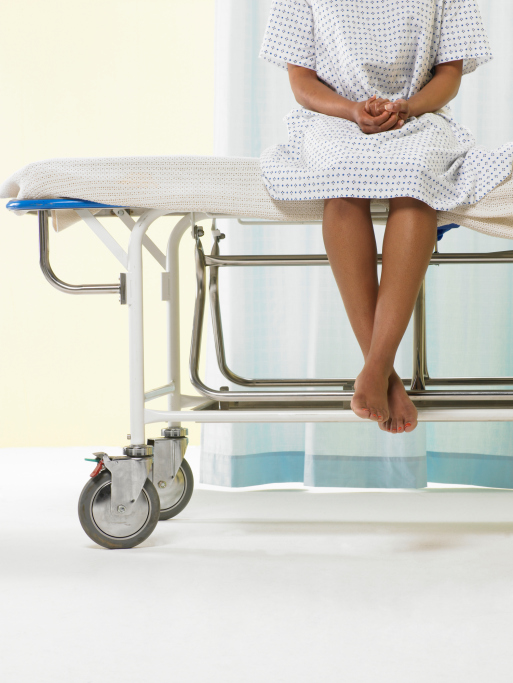 woman hospital patient sitting upright on stretcher
