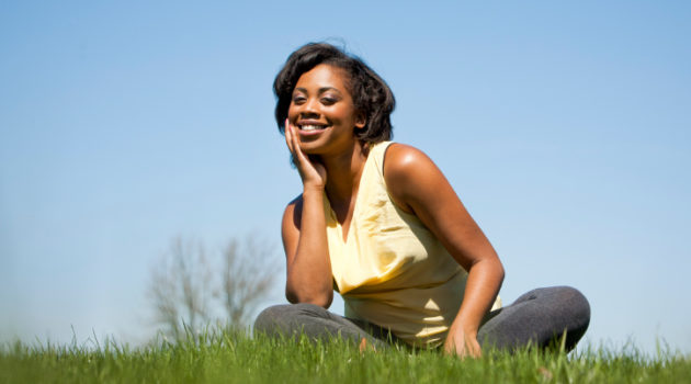 woman sitting in grass smiling