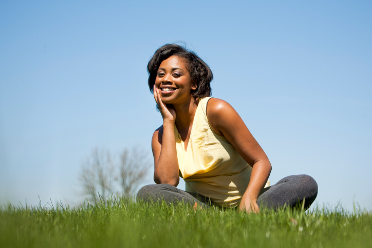 woman sitting in grass smiling