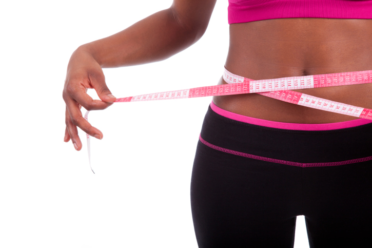 African American Black woman measuring waist
