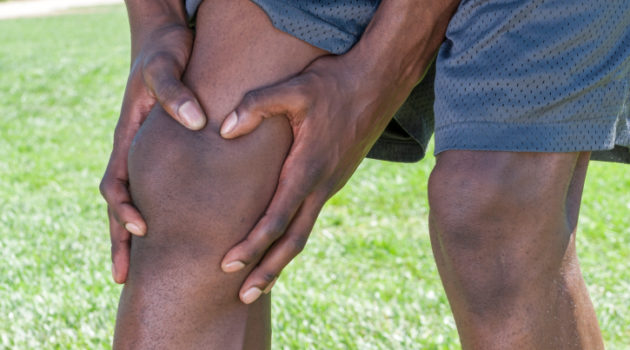 african american man holding knee