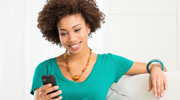 woman smiling at cell phone