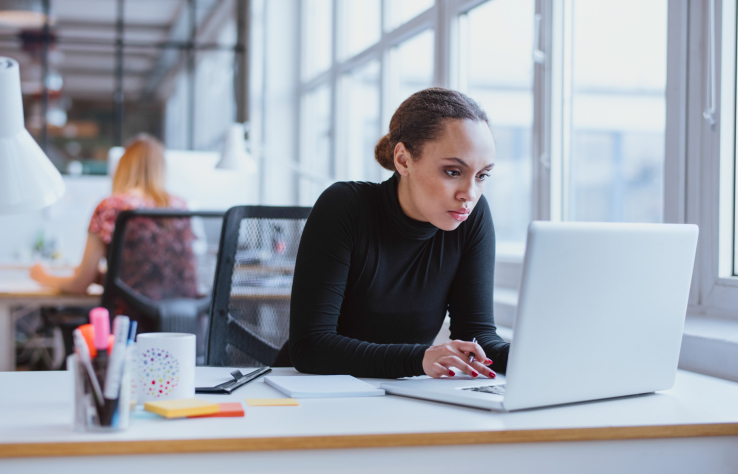 woman at work looking at laptop