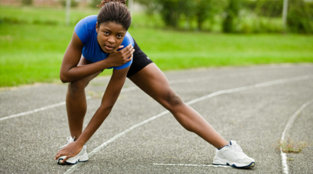 Woman stretching on track