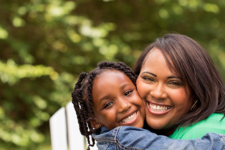mother and daughter smiling