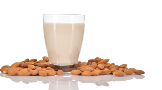 glass almond milk with almonds