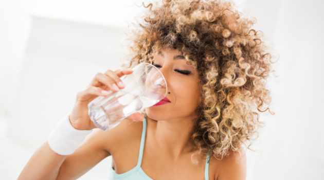 African American Black woman drinking water