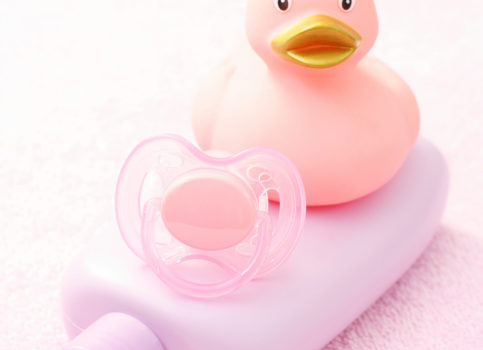 baby lotion, pacifier and plastic ducky