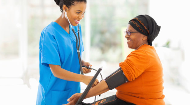 nurse taking womans blood pressure