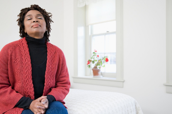 African American Black woman older meditating breathing peaceful