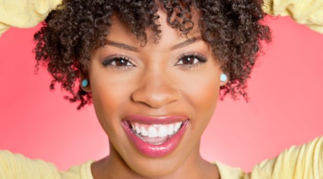African American woman smiling with curly short hair