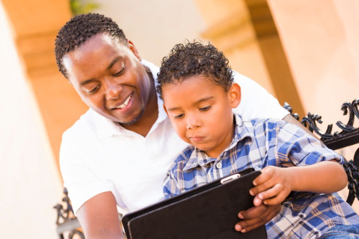 African American Black Father and Son Using Touch Pad Computer Tablet