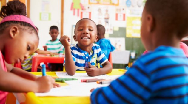 African American black boys and girl in preschool classroom