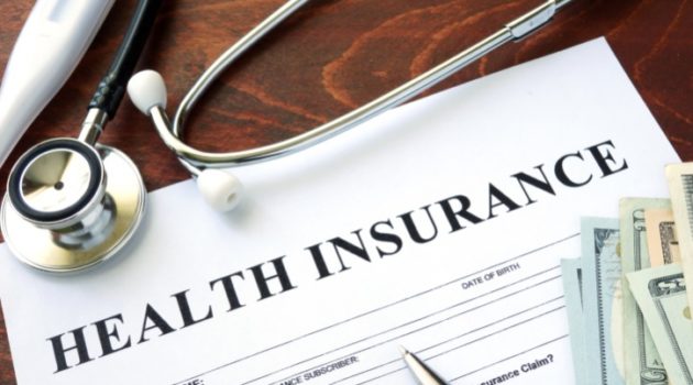 Health insurance form and dollars on the table
