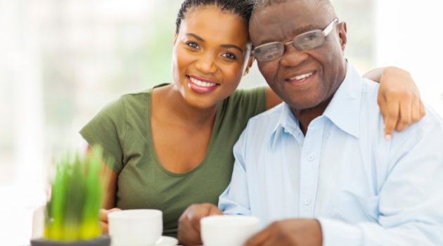 African American Black young woman and older father having coffee