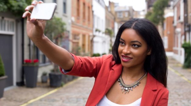 young African American Black woman taking selfie outsidie