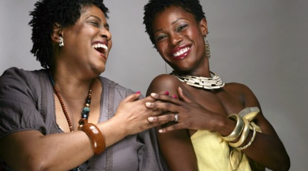 two African American women friends laughing smiling