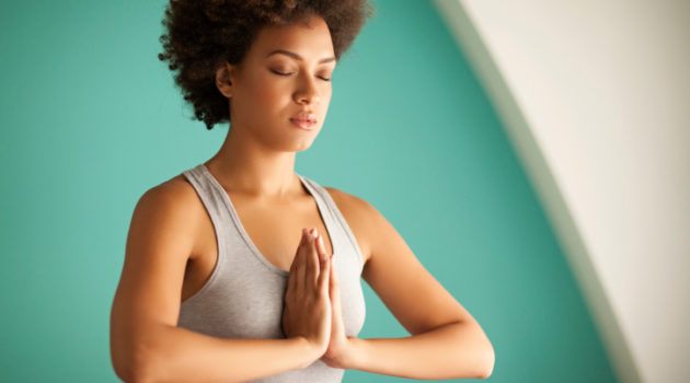 African American Black woman yoga meditation prayer position