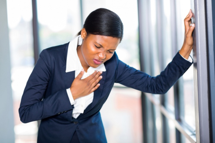 young african american businesswoman having heart attack