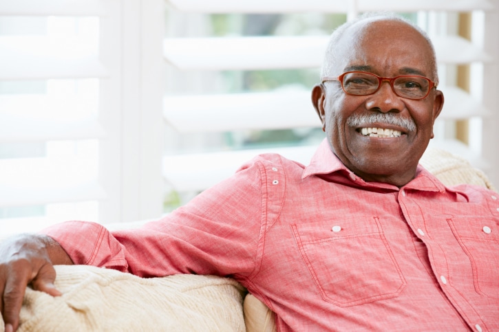 African American senior man smiling wearing glasses