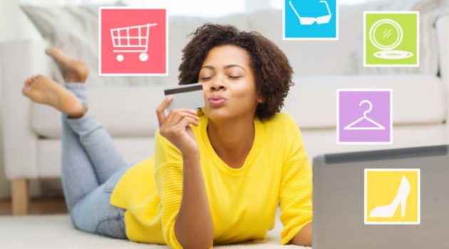 African American woman shopping on laptop with credit card