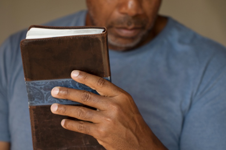 African American Black man holding bible
