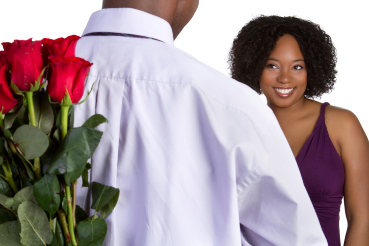 African American couple happy man holding flowers