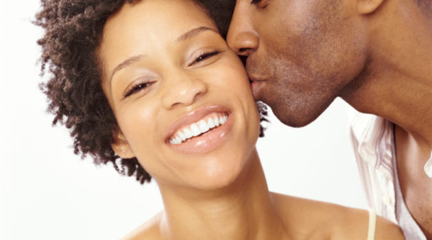 African American couple man kissing woman on cheek