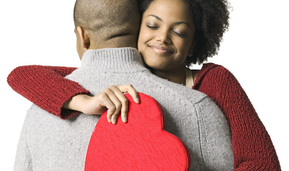 Young African American couple hugging with Valentine heart