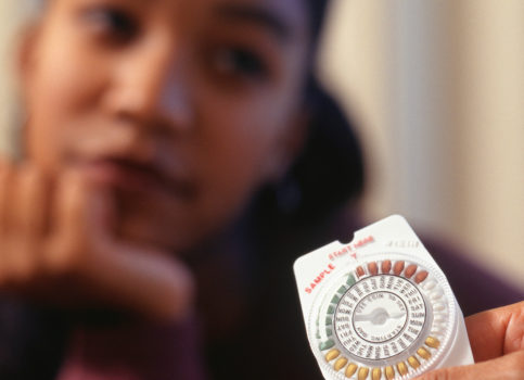 African American woman with birth control pills