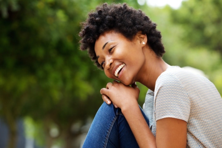 African American woman happy sitting outside