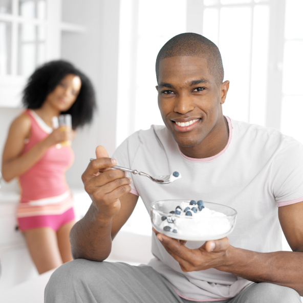 African American man eating yogurt