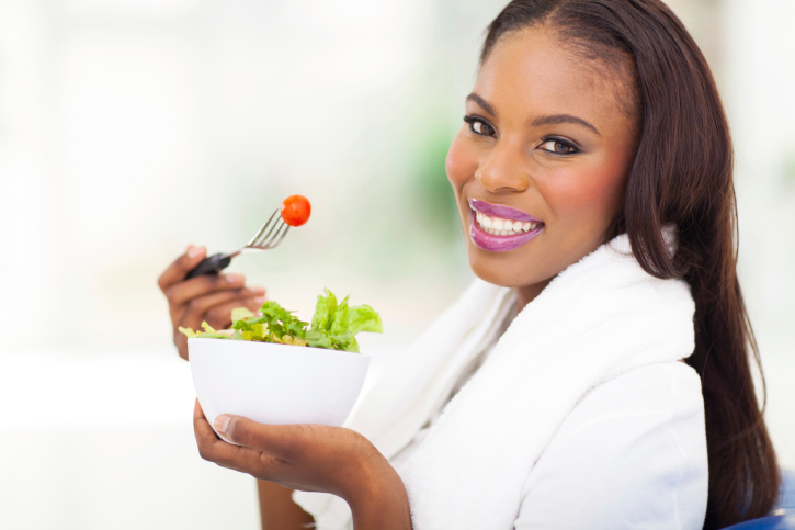 woman with long hair eating salad