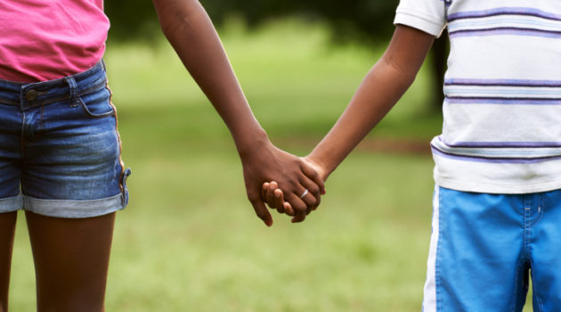 African American boy and girl holding hands