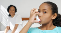 African American girl with asthma inhaler