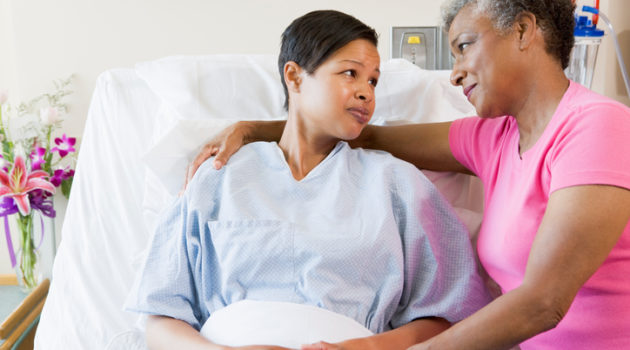 African american mother and daughter in hospital looking at each other