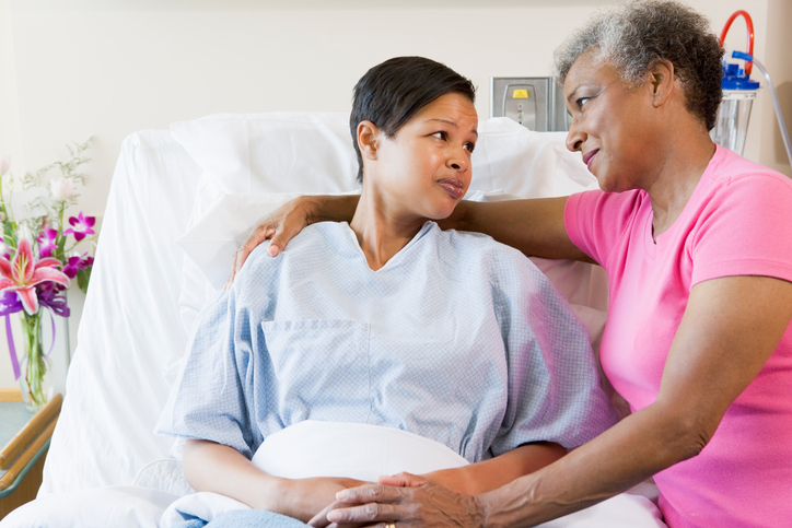 African american mother and daughter in hospital looking at each other