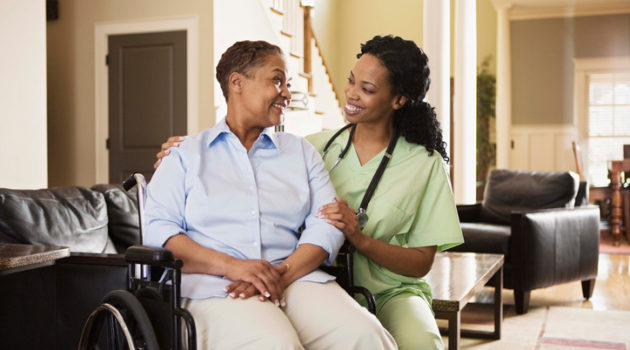 African American woman in wheelchair with nurse