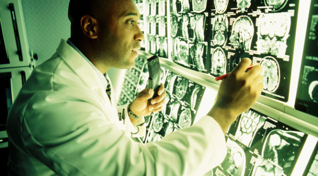 African American doctor looking at MRI scans