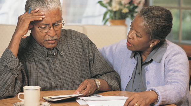 Senior African American couple going over bills