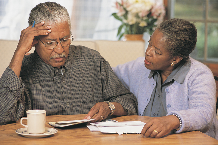 Senior African American couple going over bills