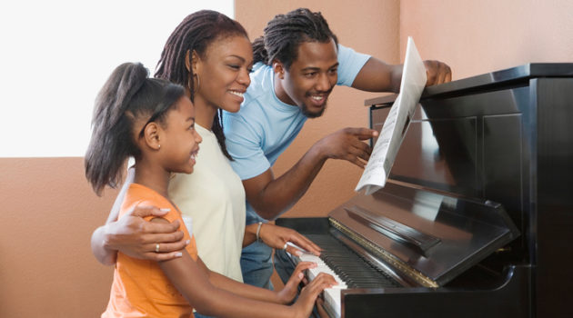 African American family playing piano