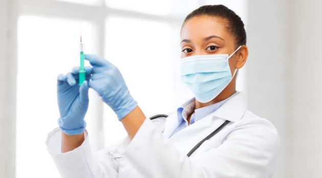 African American doctor holding needle syringe