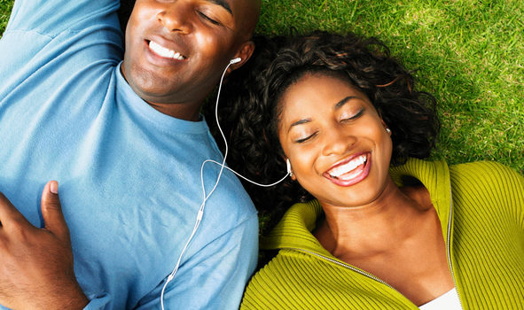 African American couple listening to music outside