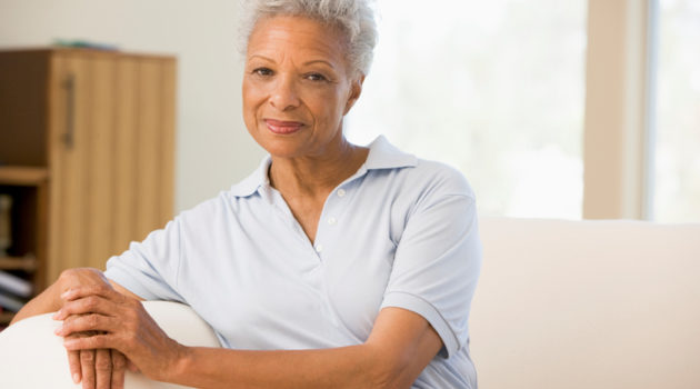 older African American woman sitting on couch